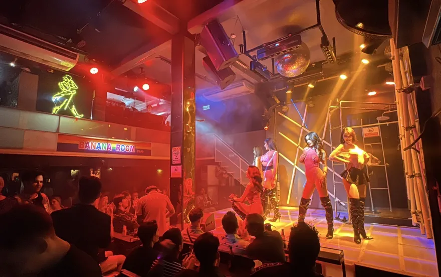 Performers on the main stage under red and blue stage lighting
